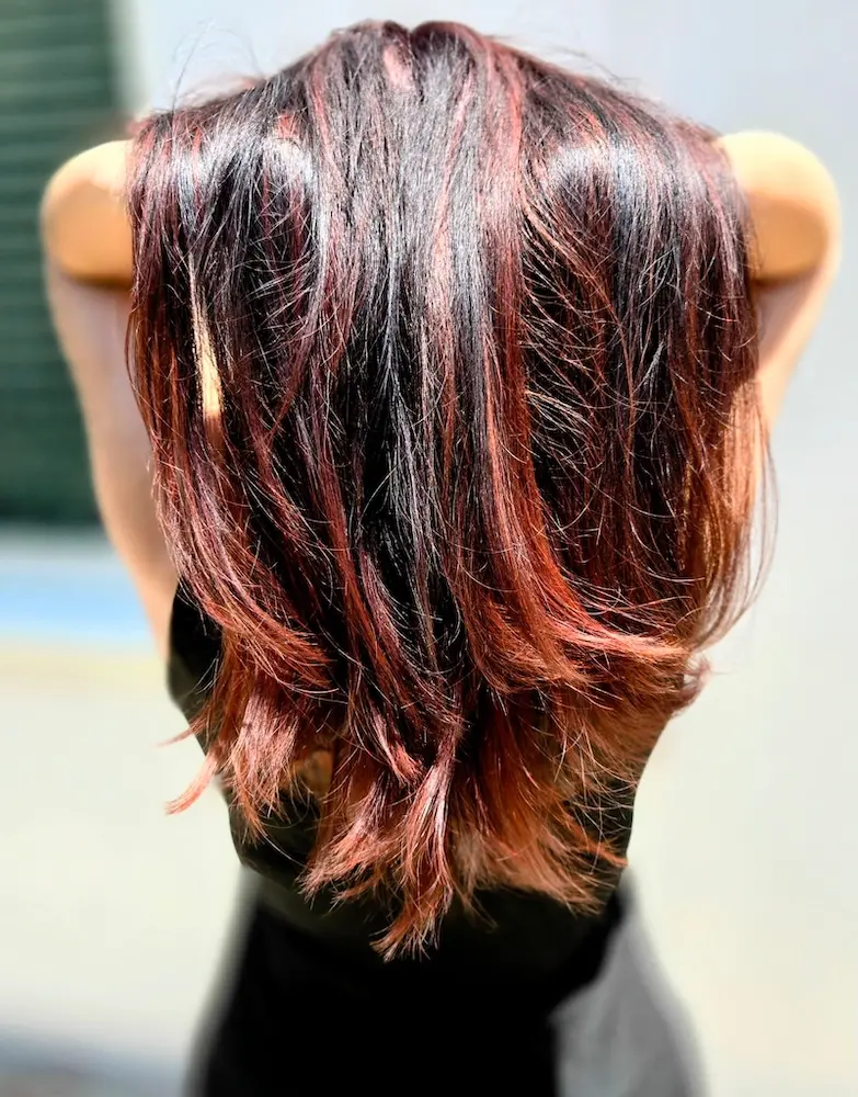 Hair color transformation showing before and after - blonde hair transformed to vibrant purple